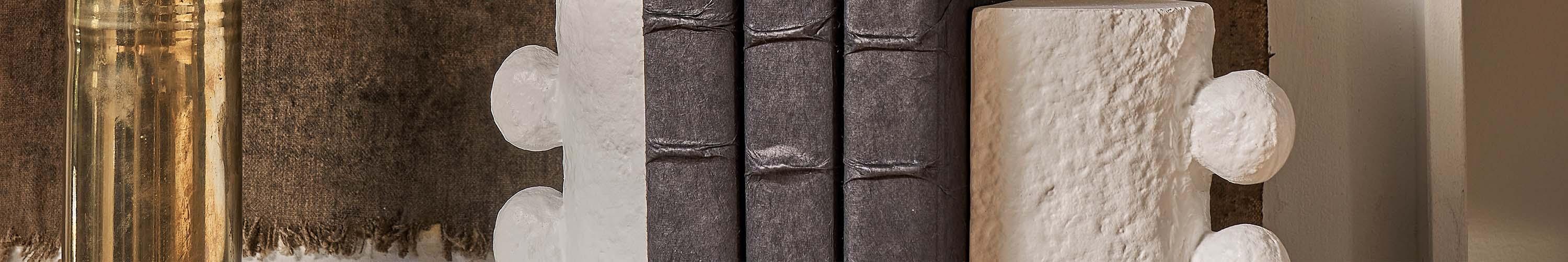 White bookends holding up brown books